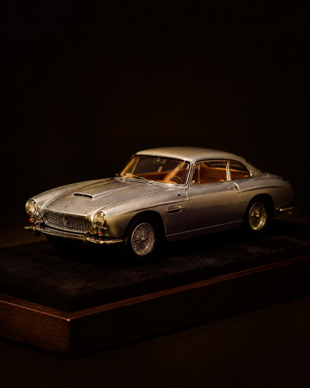 Vintage diecast grand tourer on a display base